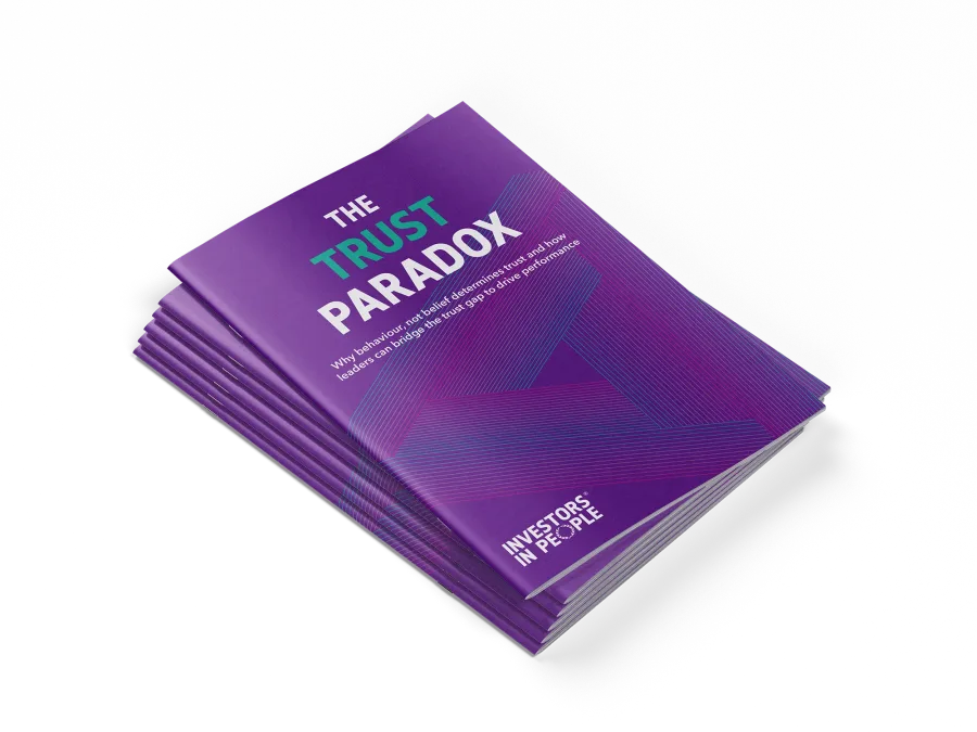 Stack of printed copies of The Trust Paradox report